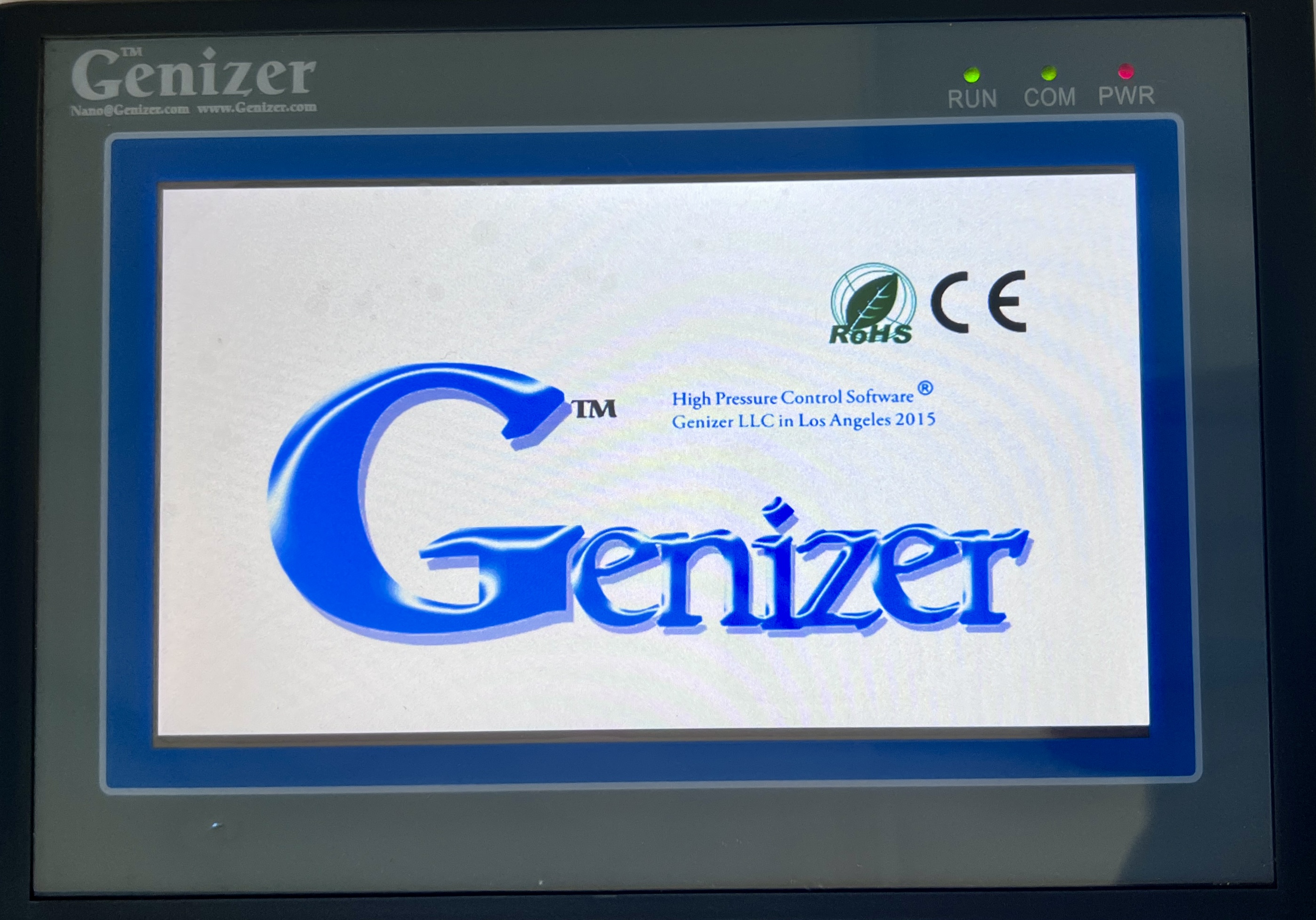 Photo of Genizer's PLC Touch Screen with Genizer's logo on the front.